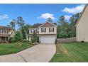 Charming two-story home featuring a two-car garage, well-manicured lawn, and lovely landscaping at 2018 Morehead Hill Ct, Durham, NC 27703