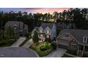 Sunset aerial view of the neighborhood showcasing well-maintained homes, mature trees, and manicured lawns at 208 Cecelia Ct, Cary, NC 27519