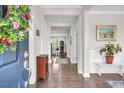 Inviting foyer with hardwood floors, a decorative wreath, and a view into the home's interior at 208 Cecelia Ct, Cary, NC 27519