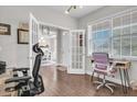 Inviting home office featuring French doors, hardwood floors, and bright natural light at 208 Cecelia Ct, Cary, NC 27519