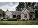 Charming brick home with manicured lawn, shrubbery, and a welcoming walkway at 2109 Taramar Ln, Zebulon, NC 27597