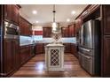 Beautiful kitchen features stainless steel appliances, granite counters, and hardwood floors at 2109 Taramar Ln, Zebulon, NC 27597