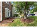 Landscaped front yard featuring healthy green grass and meticulously arranged mulch beds add curb appeal to this home at 2201 Alpine Rd, Durham, NC 27707