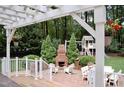 Charming backyard featuring a brick patio, outdoor fireplace, play set and well-maintained landscaping at 2216 Countrywood North Rd, Raleigh, NC 27615