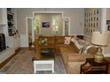 Cozy living room featuring a fireplace, built-in shelving, comfortable seating, and natural light at 2216 Countrywood North Rd, Raleigh, NC 27615