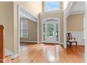 Bright foyer with hardwood floors, high ceilings, and a view to the front yard at 225 Norwalk St, Holly Springs, NC 27540