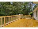 Large wooden deck perfect for outdoor entertaining, surrounded by trees at 231 Harris Rd, Smithfield, NC 27577