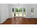 Bright dining area with bay window, wood floors, and access to deck at 231 Harris Rd, Smithfield, NC 27577