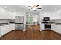 Modern kitchen with stainless steel appliances, white cabinets, and open floor plan at 231 Harris Rd, Smithfield, NC 27577