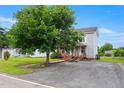 A two-story home with a covered front porch and ramp access, with an asphalt driveway at 2527 Ossipee Front St, Elon, NC 27244