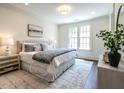 Bright bedroom featuring neutral decor, plush bedding, and ample natural light at 2652 Welham Aly, Raleigh, NC 27608