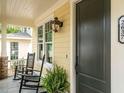 Inviting front porch with black rocking chairs and a decorative outdoor lantern at 2652 Welham Aly, Raleigh, NC 27608