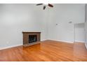 Bright living room with hardwood floors and a brick fireplace for cozy evenings at 3306 Woodland Park Rd, Durham, NC 27703