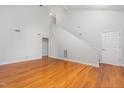 An open concept living room with hardwood flooring, neutral walls, and high ceilings at 3306 Woodland Park Rd, Durham, NC 27703