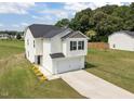 Aerial view of a two-story home with a two-car garage and well-maintained lawn and landscaping at 4097 Cordiality Church Rd, Nashville, NC 27856
