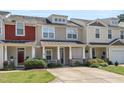Charming townhouse with a cozy front porch, complete with well-kept lawn and traditional architectural details at 4807 Landover Charge Ln, Raleigh, NC 27616