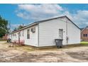 Rear exterior view of a multi-unit home showcasing backyard and basic amenities at 501 Magnolia Dr, Rocky Mount, NC 27801