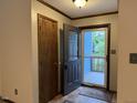 Inviting entryway featuring a stylish door with glass inserts and a glimpse of the front porch at 507 Holtz Ln, Cary, NC 27511