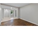 Cozy bedroom with light gray walls, gleaming wood floors, and a walk-in shower at 519 W Raleigh St, Siler City, NC 27344
