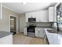 Bright kitchen featuring stainless steel appliances, granite countertops, and light wood floors at 519 W Raleigh St, Siler City, NC 27344