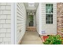 Home entrance features a stone-lined walkway with a light-filled portico at 5233 Greymoss Ln, Apex, NC 27539