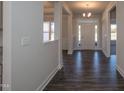 Bright and spacious foyer with hardwood floors and elegant lighting, showcasing the home's entry at 61 Merrifield Ln, Garner, NC 27529