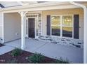 Inviting front porch with stone accents and well-kept landscaping for a welcoming entry at 61 Merrifield Ln, Garner, NC 27529