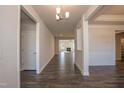 Long hallway with hardwood floors leading to various rooms, creating a sense of spaciousness at 61 Merrifield Ln, Garner, NC 27529