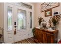 Welcoming foyer with decorative glass doors, hardwood floors, and elegant decor at 67 Marshlane Way, Clayton, NC 27527