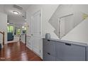Bright foyer with hardwood floors, storage console, and staircase at 740 Treviso Ln, Apex, NC 27502