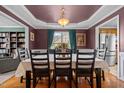Traditional dining room featuring hardwood floors, modern lighting fixture, and a large picture window at 76 Haywood St, Spring Lake, NC 28390