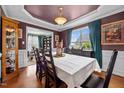 A formal dining room with hardwood floors, a table with seating for six, and detailed trim work at 76 Haywood St, Spring Lake, NC 28390