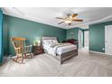 Spacious main bedroom featuring a tray ceiling, ceiling fan, and neutral carpet at 76 Haywood St, Spring Lake, NC 28390
