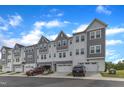 Charming townhome community featuring a two car garage, neutral gray tones and professional landscaping at 816 Lilyquist Way, Wake Forest, NC 27587