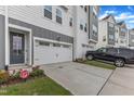 New home featuring an attached two-car garage and inviting gray front door at 816 Lilyquist Way, Wake Forest, NC 27587