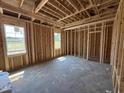 Unfinished bedroom featuring natural lighting and bare studs, ready to be customized at 82 Laramie Ln, Selma, NC 27576