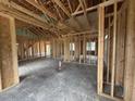 Open floor plan showing wooden framework, cathedral ceiling, and generous space for customization at 82 Laramie Ln, Selma, NC 27576