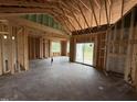 Spacious living room showing wooden framework, ample natural light, sliding glass doors to the outside at 82 Laramie Ln, Selma, NC 27576