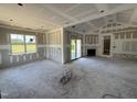 Unfinished living room with fireplace, sliding doors to backyard, and abundant light at 82 Laramie Ln, Selma, NC 27576