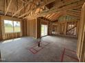 Unfinished living room featuring an open layout with access to the backyard through a sliding glass door at 82 Laramie Ln, Selma, NC 27576