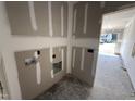 Mud room displays unfinished walls with cutouts for plumbing at 82 Laramie Ln, Selma, NC 27576