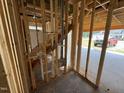 The unfinished staircase leads upstairs; with view to exterior; exposing new home's framework at 82 Laramie Ln, Selma, NC 27576