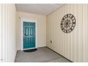 Inviting entryway featuring a teal door and decorative metal artwork enhancing curb appeal at 826 Downfield Ln, Fuquay Varina, NC 27526