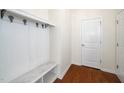 Well-organized mudroom area with hooks, shelving, and bench seating for convenient storage at 826 Downfield Ln, Fuquay Varina, NC 27526