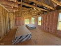Sunlit interior with insulation and exposed framing, ready for drywall and finishing touches at 90 Brookhaven Dr, Spring Hope, NC 27882