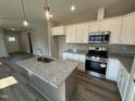 Bright kitchen with stainless steel appliances, granite countertops, and an island sink at 90 Brookhaven Dr, Spring Hope, NC 27882