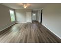Bright living room featuring light walls, wood floors, and natural light from the window at 90 Brookhaven Dr, Spring Hope, NC 27882