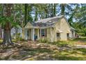 Quaint yellow home showcasing its siding, columns, and inviting front entrance at 940 Hill St, Rocky Mount, NC 27801