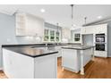 Modern kitchen with white cabinetry, stainless steel appliances and hardwood flooring at 9509 Greenfield Dr, Raleigh, NC 27615