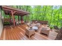 Inviting back deck with comfortable seating, an open dining area, and serene views of the surrounding lush greenery at 1 Davie Ln, Chapel Hill, NC 27514